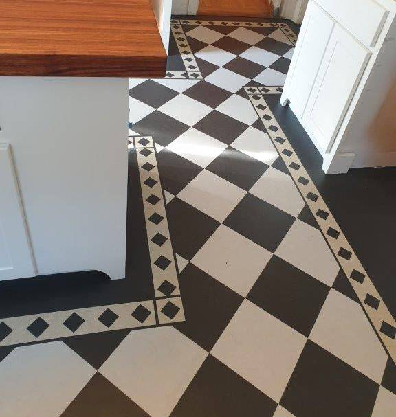 A new Forbo Marmoleum Linoleum floor installed in the kitchen with a checkerboard design.