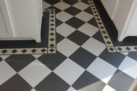 A new Forbo Marmoleum Linoleum floor installed in the kitchen with a checkerboard design.