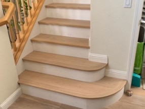 Hardwood flooring on stairs freshly refinished.